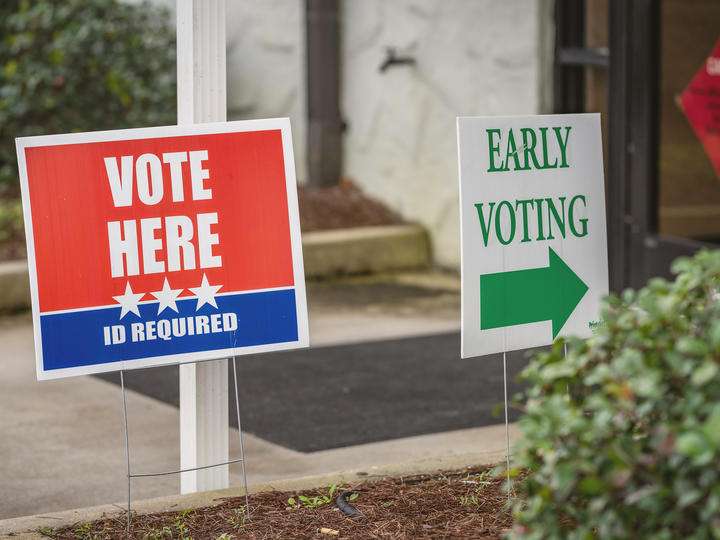 Signs in front of building read vote here and early voting