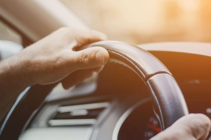 Hands on a steering wheel.